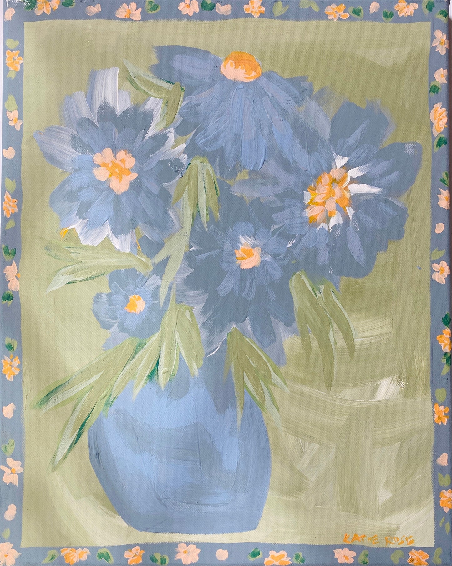 A painting featuring a blue vase with blue flowers, surrounded by a light green and yellow floral patterned border.